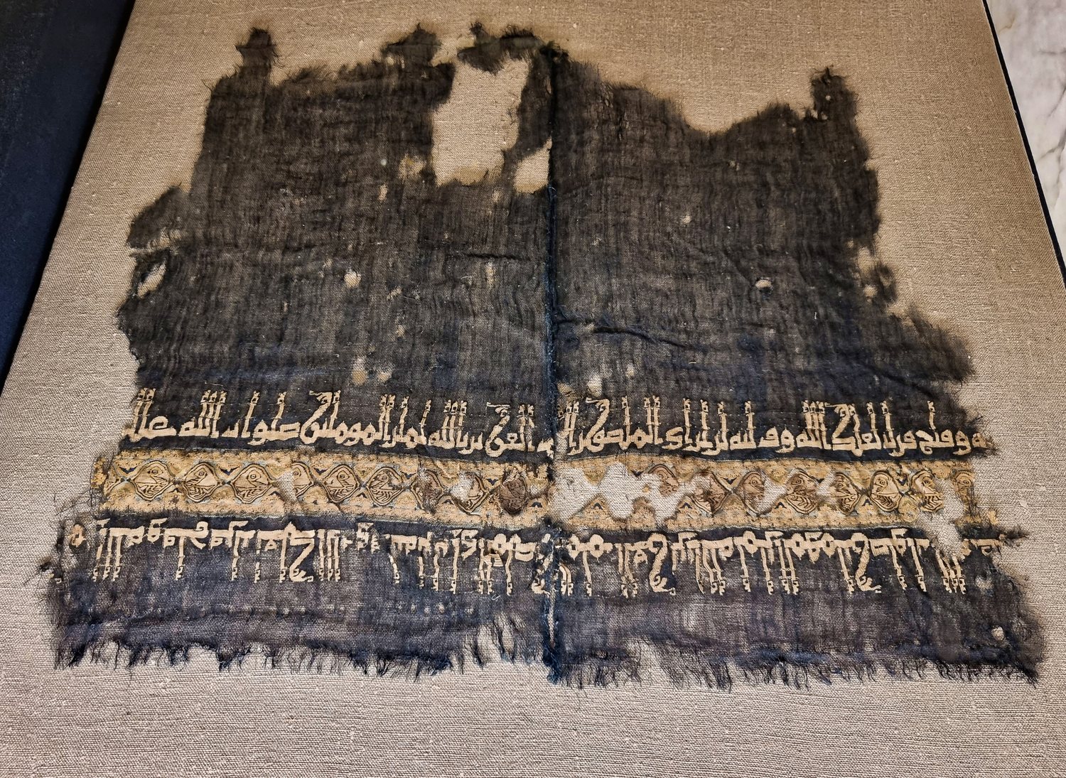Detail view of an early Islamic textile at NMEC